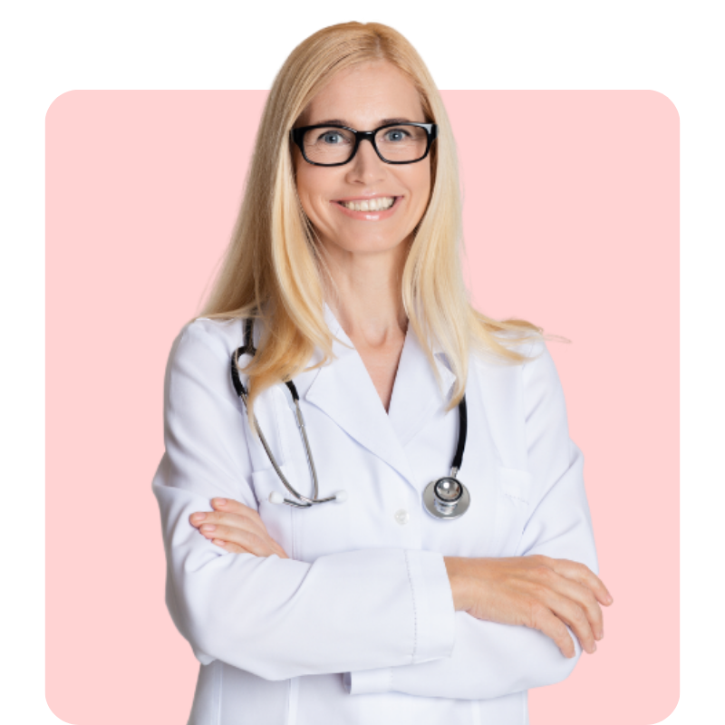 A blonde woman in glasses, wearing a lab coat, stands confidently with her arms folded, radiating a warm smile against a vibrant pink background.